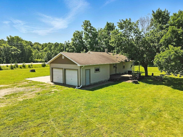 2314 347th Ave NE, Cambridge Twp, MN 55008 - rear view of house featuring a detached garage, a lawn, and a shingled roof