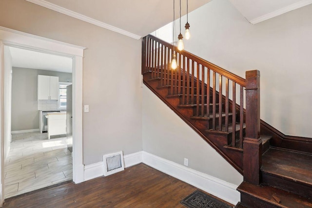 1535 Sherburne Ave, Saint Paul, MN 55104 - staircase with wood finished floors and crown molding
