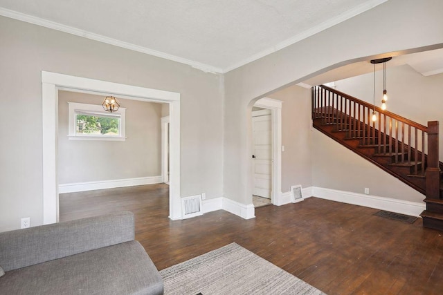 1535 Sherburne Ave, Saint Paul, MN 55104 - unfurnished living room with arched walkways, wood finished floors, stairway, and crown molding