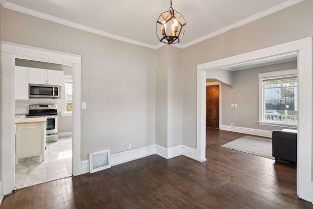 1535 Sherburne Ave, Saint Paul, MN 55104 - unfurnished dining area featuring hardwood / wood-style flooring, ornamental molding, arched walkways, and a chandelier
