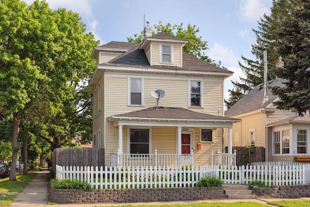 1535 Sherburne Ave, Saint Paul, MN 55104 - american foursquare style home featuring covered porch, a fenced front yard, and roof with shingles