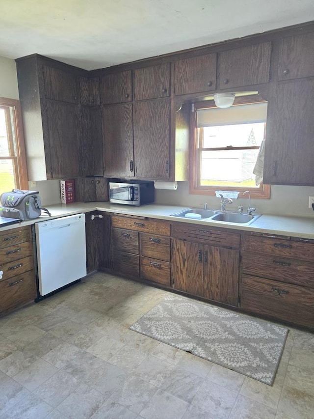 36789 State Highway 22, New Sweden Twp, MN 56082 - kitchen featuring white dishwasher, stainless steel microwave, light countertops, and healthy amount of natural light