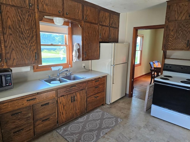 36789 State Highway 22, New Sweden Twp, MN 56082 - kitchen with white appliances and light countertops