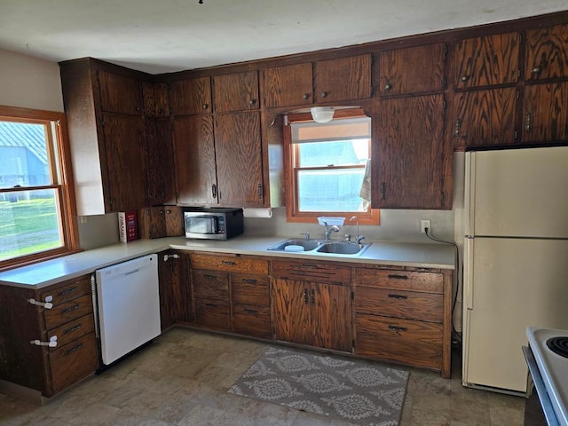 36789 State Highway 22, New Sweden Twp, MN 56082 - kitchen with white appliances, light countertops, and plenty of natural light
