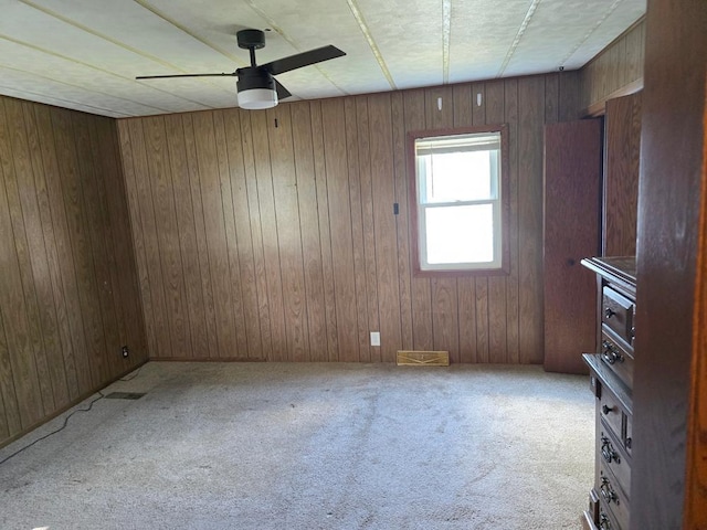36789 State Highway 22, New Sweden Twp, MN 56082 - unfurnished room featuring a ceiling fan, carpet, and wood walls