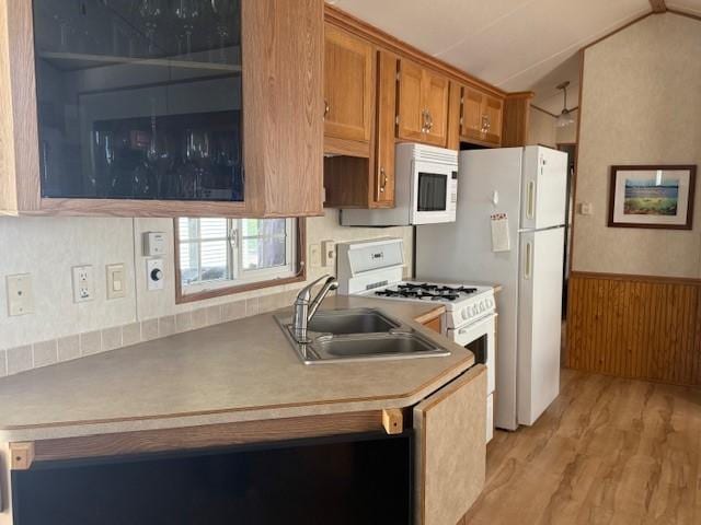 5055 Lake Mary Dr SW Unit 18, Alexandria, MN 56308 - kitchen with white appliances, brown cabinets, light wood-style floors, vaulted ceiling, and a wainscoted wall