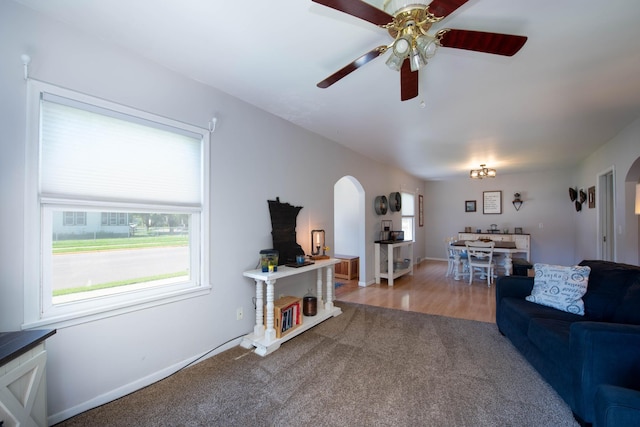 202 Silver St E, Mapleton, MN 56065 - living area featuring arched walkways, carpet floors, and ceiling fan