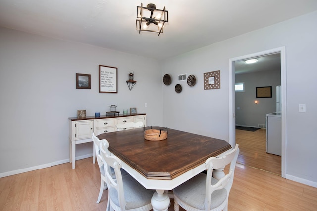 202 Silver St E, Mapleton, MN 56065 - dining room with light wood-type flooring and a chandelier