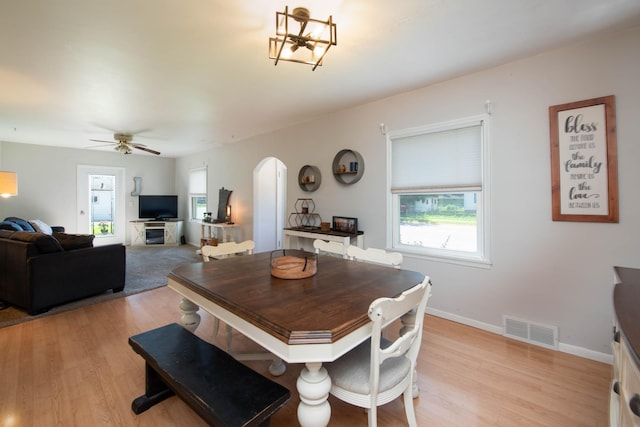 202 Silver St E, Mapleton, MN 56065 - dining space featuring arched walkways, light wood-type flooring, and ceiling fan