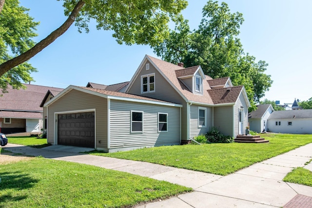 202 Silver St E, Mapleton, MN 56065 - view of front facade with a front yard, a shingled roof, driveway, and an attached garage
