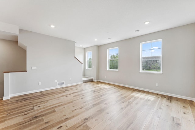 7443 E Ramsey Pkwy NW, Ramsey, MN 55303 - unfurnished room with light wood-type flooring, stairway, and recessed lighting