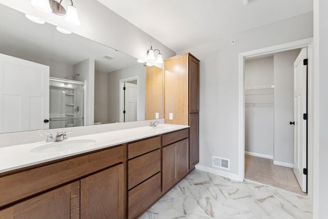 7443 E Ramsey Pkwy NW, Ramsey, MN 55303 - full bath featuring a stall shower, double vanity, a spacious closet, and marble finish floors