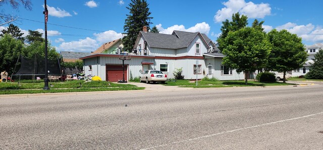 625 2nd Ave NE, Staples, MN 56479 - view of front of property with a trampoline, a garage, and a chimney