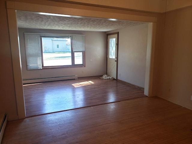 625 2nd Ave NE, Staples, MN 56479 - empty room featuring baseboard heating and wood finished floors