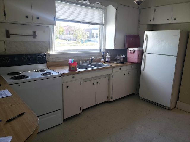 625 2nd Ave NE, Staples, MN 56479 - kitchen featuring white appliances, white cabinetry, light countertops, and tasteful backsplash