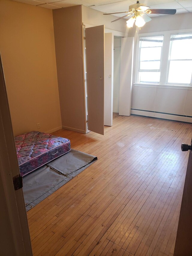 625 2nd Ave NE, Staples, MN 56479 - bedroom featuring a baseboard radiator, light wood-type flooring, and ceiling fan