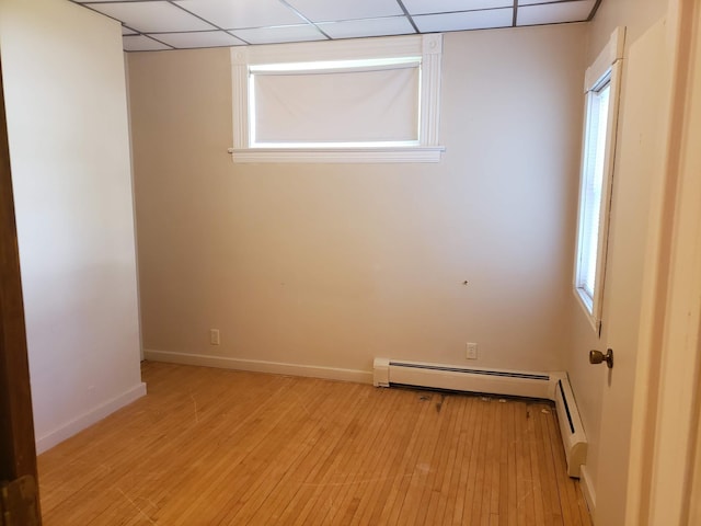 625 2nd Ave NE, Staples, MN 56479 - spare room featuring a baseboard heating unit, light wood finished floors, and a drop ceiling