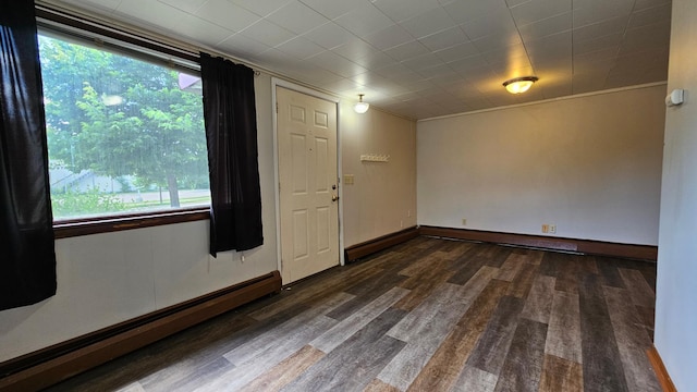 625 2nd Ave NE, Staples, MN 56479 - spare room featuring a baseboard radiator, plenty of natural light, and wood finished floors