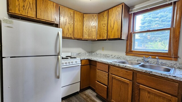 625 2nd Ave NE, Staples, MN 56479 - kitchen with white appliances, brown cabinets, light countertops, and dark wood finished floors
