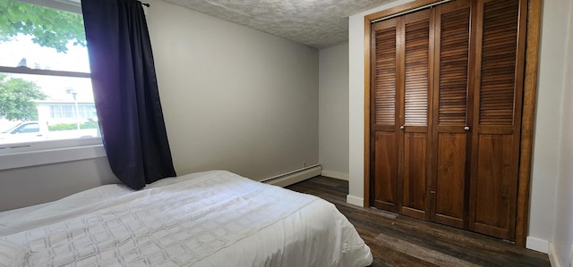 625 2nd Ave NE, Staples, MN 56479 - bedroom featuring a baseboard radiator, a closet, dark wood-type flooring, and a textured ceiling
