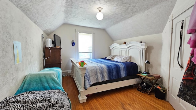 625 2nd Ave NE, Staples, MN 56479 - bedroom featuring wood-type flooring, a textured ceiling, and lofted ceiling