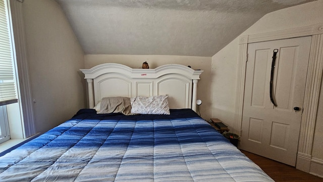 625 2nd Ave NE, Staples, MN 56479 - bedroom featuring vaulted ceiling, a textured ceiling, and wood finished floors