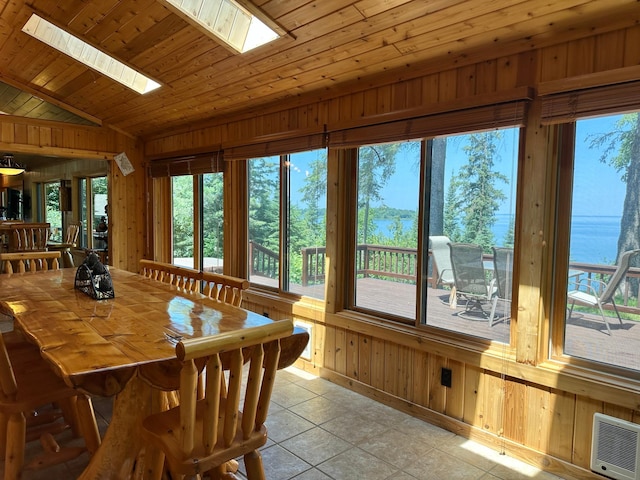 1938 Pine Cliff Rd NW, Walker, MN 56484 - dining area with a skylight, wood walls, healthy amount of natural light, light tile patterned floors, and lofted ceiling