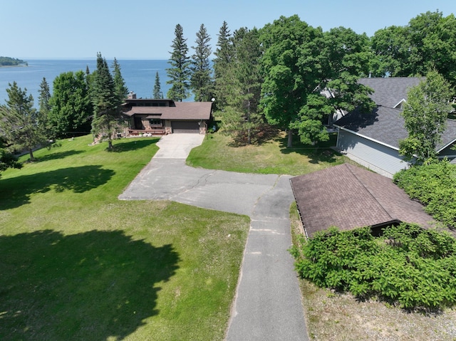 1938 Pine Cliff Rd NW, Walker, MN 56484 - view of grassy yard featuring a water view, driveway, and a garage