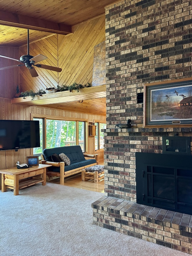 1938 Pine Cliff Rd NW, Walker, MN 56484 - living area featuring wooden walls, a wooden ceiling with exposed beams, carpet, ceiling fan, and a fireplace