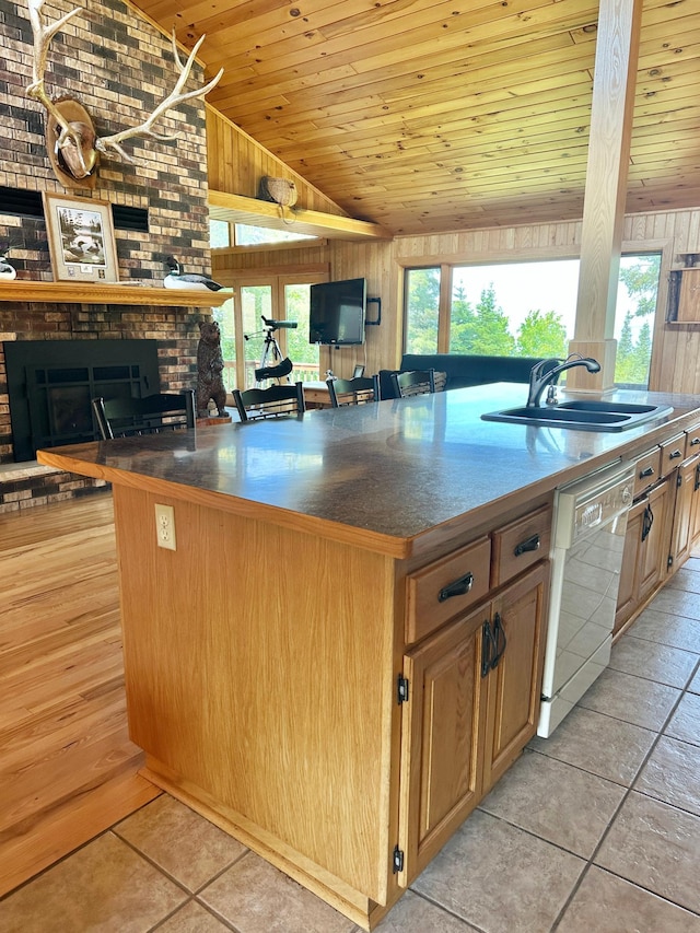1938 Pine Cliff Rd NW, Walker, MN 56484 - kitchen with white dishwasher, vaulted ceiling, wood ceiling, a fireplace, and a center island with sink