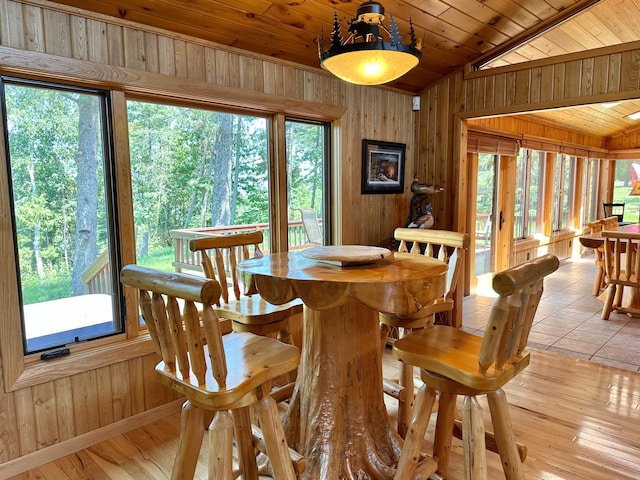 1938 Pine Cliff Rd NW, Walker, MN 56484 - dining room featuring wood walls, vaulted ceiling, healthy amount of natural light, wooden ceiling, and light wood-type flooring