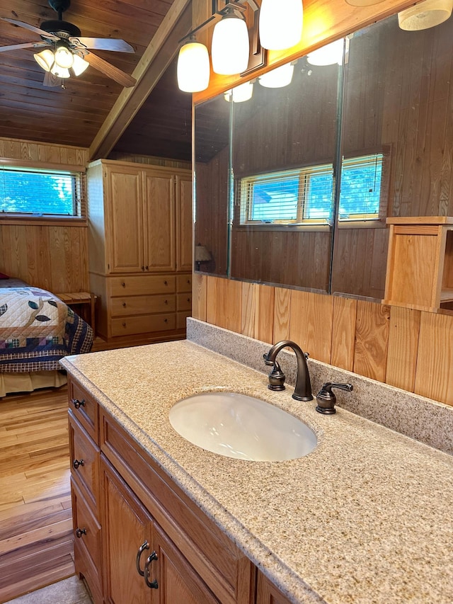 1938 Pine Cliff Rd NW, Walker, MN 56484 - bathroom with wooden walls, wood ceiling, vanity, wood finished floors, and a ceiling fan