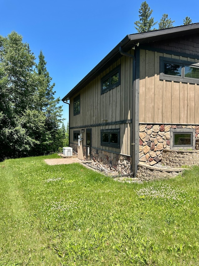 1938 Pine Cliff Rd NW, Walker, MN 56484 - view of property exterior featuring a lawn, board and batten siding, and stone siding