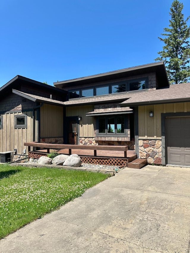 1938 Pine Cliff Rd NW, Walker, MN 56484 - view of front of property with stone siding, a garage, and board and batten siding