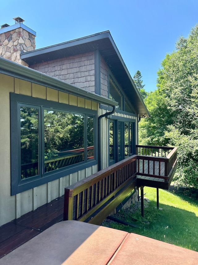 1938 Pine Cliff Rd NW, Walker, MN 56484 - view of side of home with a wooden deck and a chimney