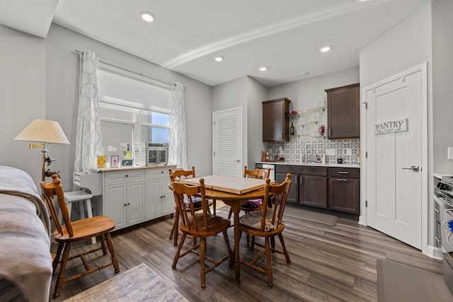 4617 Cobalt Ln, Woodbury, MN 55129 - dining space featuring dark wood-style flooring, a dry bar, recessed lighting, and cooling unit