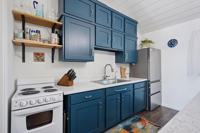 68018 217th St, Ellsworth Twp, MN 55324 - kitchen featuring white range with electric stovetop, blue cabinetry, dark wood-type flooring, light countertops, and open shelves