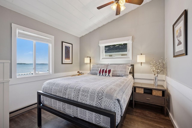 68018 217th St, Ellsworth Twp, MN 55324 - bedroom with a baseboard radiator, vaulted ceiling, wood finished floors, a water view, and a ceiling fan