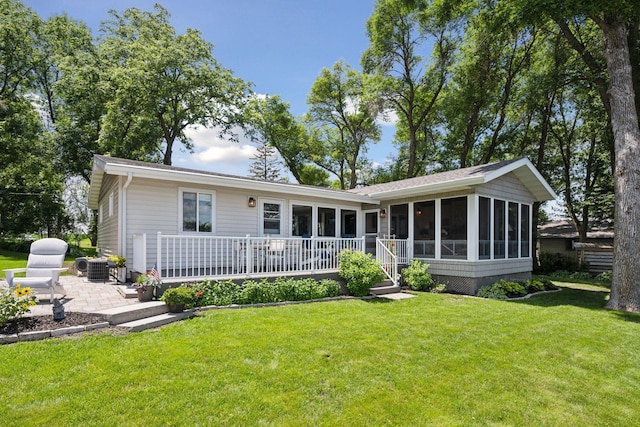 68018 217th St, Ellsworth Twp, MN 55324 - back of property featuring a sunroom, a yard, and a patio area