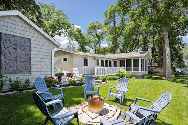 68018 217th St, Ellsworth Twp, MN 55324 - back of house with a fire pit, a sunroom, a lawn, and a patio area