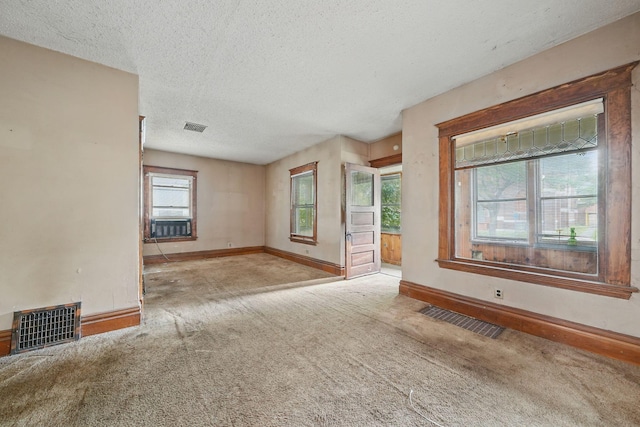 2918 15th Ave S, Minneapolis, MN 55407 - unfurnished room featuring carpet, a textured ceiling, and cooling unit