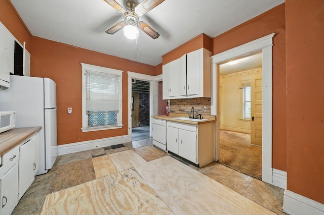 2918 15th Ave S, Minneapolis, MN 55407 - kitchen with white appliances, light countertops, a ceiling fan, and white cabinetry