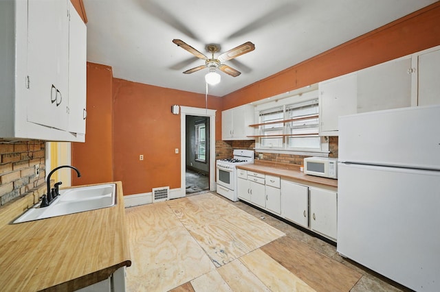 2918 15th Ave S, Minneapolis, MN 55407 - kitchen featuring white appliances, ceiling fan, white cabinetry, and backsplash