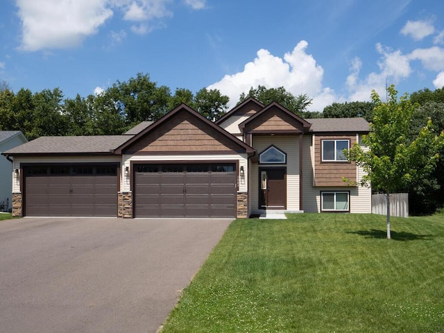 1049 Bellaire Blvd NW, Isanti, MN 55040 - view of front of home featuring a garage, driveway, a front lawn, and stone siding