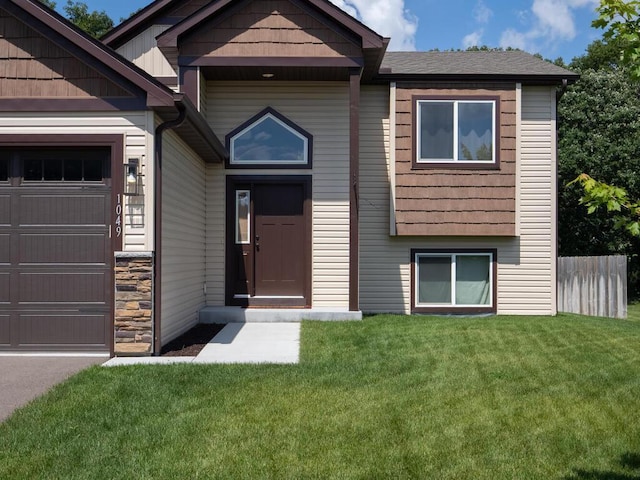 1049 Bellaire Blvd NW, Isanti, MN 55040 - view of front of property featuring a garage and stone siding