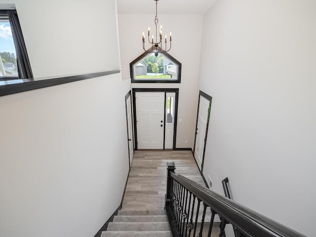 1049 Bellaire Blvd NW, Isanti, MN 55040 - foyer entrance featuring a chandelier, healthy amount of natural light, light wood-style flooring, and stairway