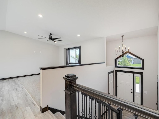 1049 Bellaire Blvd NW, Isanti, MN 55040 - hall featuring an upstairs landing, a chandelier, light wood-style floors, vaulted ceiling, and recessed lighting