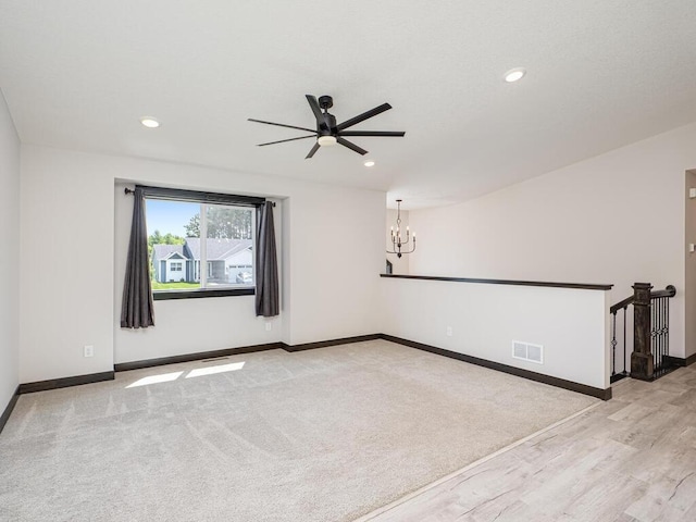 1049 Bellaire Blvd NW, Isanti, MN 55040 - spare room with ceiling fan, a chandelier, recessed lighting, and wood finished floors