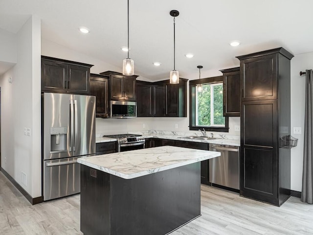 1049 Bellaire Blvd NW, Isanti, MN 55040 - kitchen with stainless steel appliances, light wood finished floors, dark brown cabinetry, light countertops, and recessed lighting