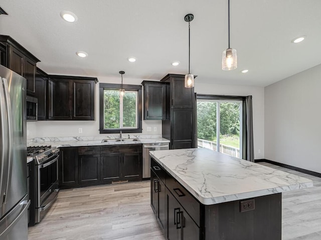 1049 Bellaire Blvd NW, Isanti, MN 55040 - kitchen with appliances with stainless steel finishes, recessed lighting, a kitchen island, light wood finished floors, and pendant lighting